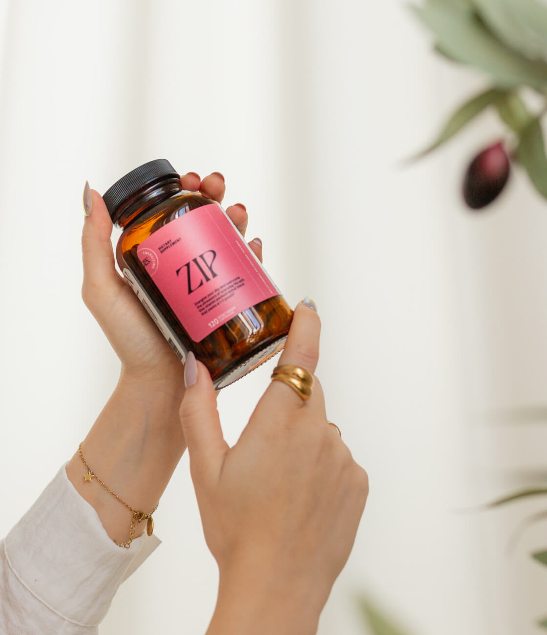 Our prestige blend of vitamins and minerals make this supplement the ultimate way to relieve stress, treat fatigue and still look beautiful enough to display on your counter. [AD: A womans hand, with gold jewlerry, holds a bottle of Zip delicately with a cream backdrop and olive tree in the background]